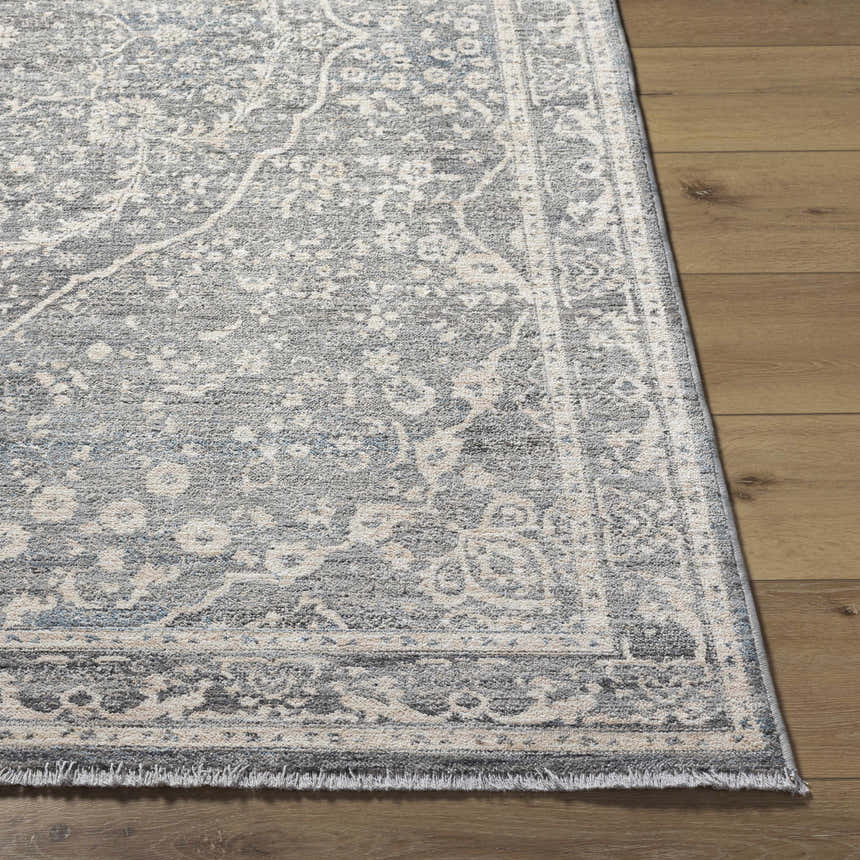 Close-up of the Anouk Area Rug, a gray traditional rug with a floral pattern on a wood floor. Front