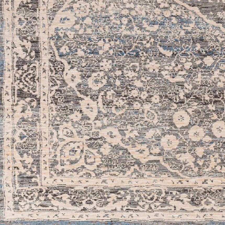 Close-up of the Anouk Area Rug featuring a traditional design in dark gray, light gray, and blue. Swatch