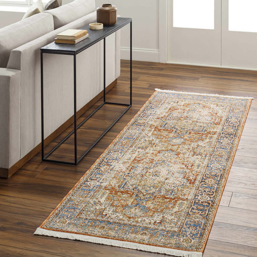 Living room scene with a Basim Area Rug runner in bone, charcoal, copper, and rust colors. Farmhouse style rug on wood floor. Roomscene-Runner