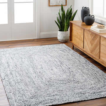 Living room scene with a gray Kenyi Natural Gray Area Rug, wood floors, and a mid-century modern cabinet. Roomscene-Rectangle