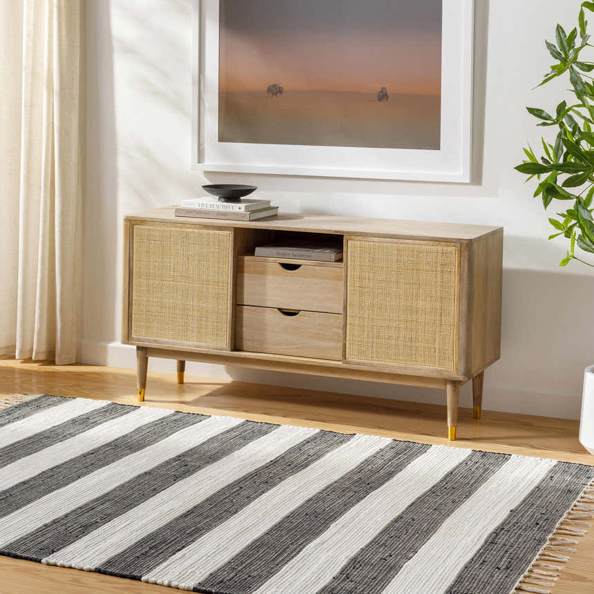 Living room scene with Moby Charcoal Area Rug featuring bold black and white stripes under a wood console table. Roomscene-Rectangle