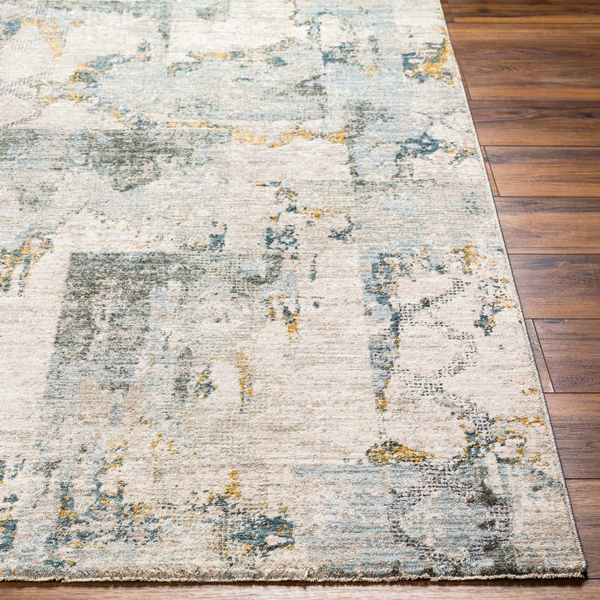 Close-up of the Adlai Textured Rug showing the off-white, blue, gray, and mustard colors and textured design. Front