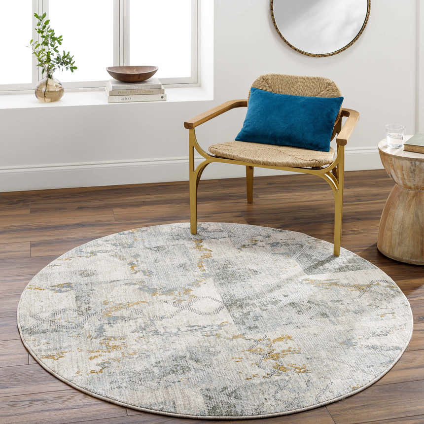Living room scene with round Adlai Textured Rug in light gray, blue, and mustard colors. Roomscene-Round