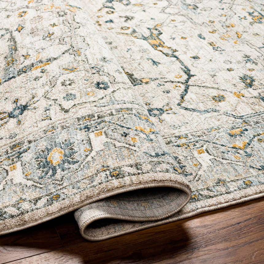 Close-up of the Aviva Off-White Textured Rug showing its traditional design, dusty sage, light gray, and mustard colors. Fold