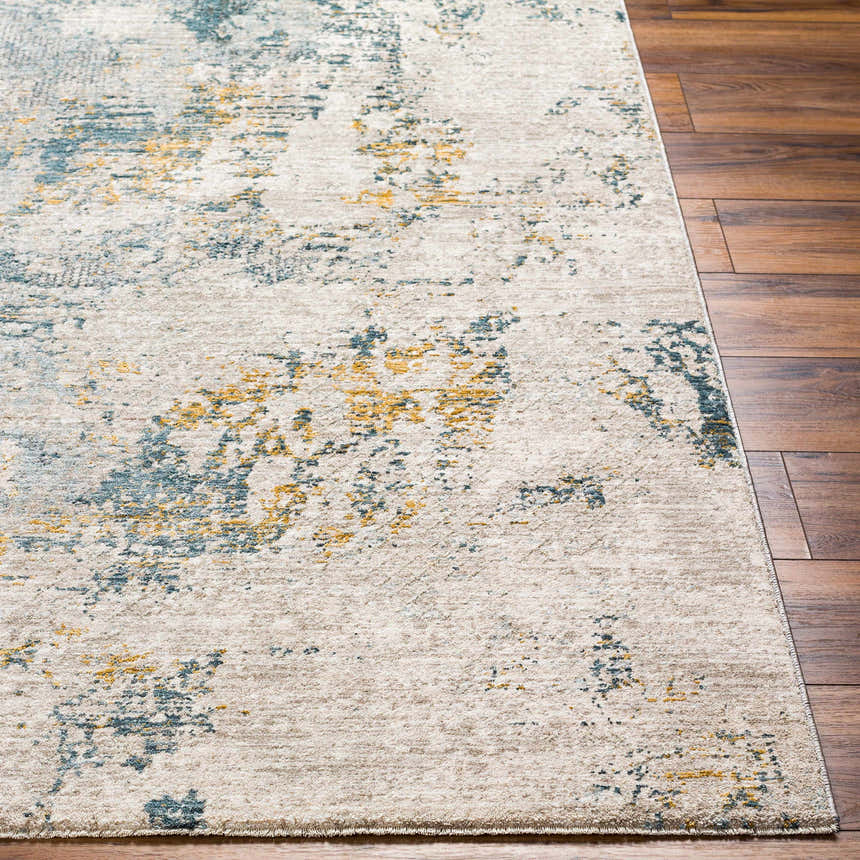 Close-up of the Chaya Textured Abstract Rug with Fringes. Colors include dusty sage, ink blue, mustard, and off white. Front