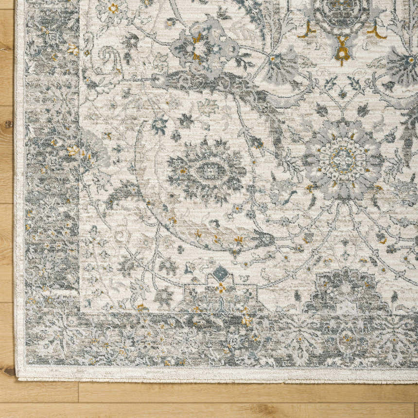 Close up of Gauge Cream & Gray Blue Rug showing traditional floral pattern and soft texture. Corner