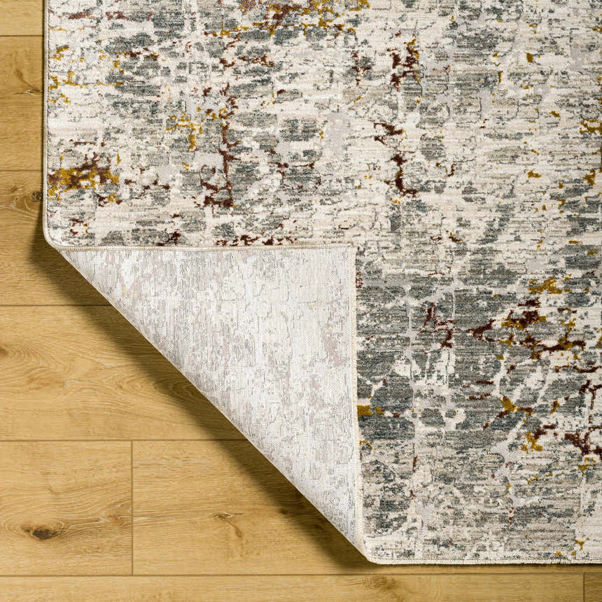 Close-up of the Kasim Textured Rug in light gray, showing its abstract pattern and texture on a wood floor. Fold