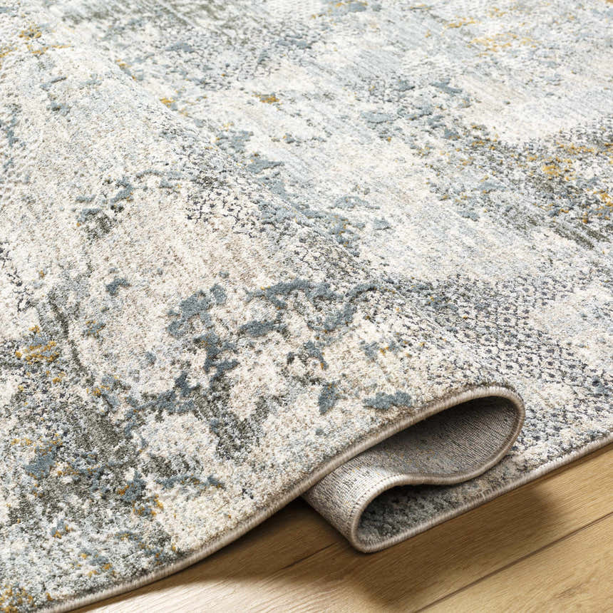 Close-up of the Pizi Textured Rug showing its light gray, ink blue, and mustard contemporary design and soft texture. Fold