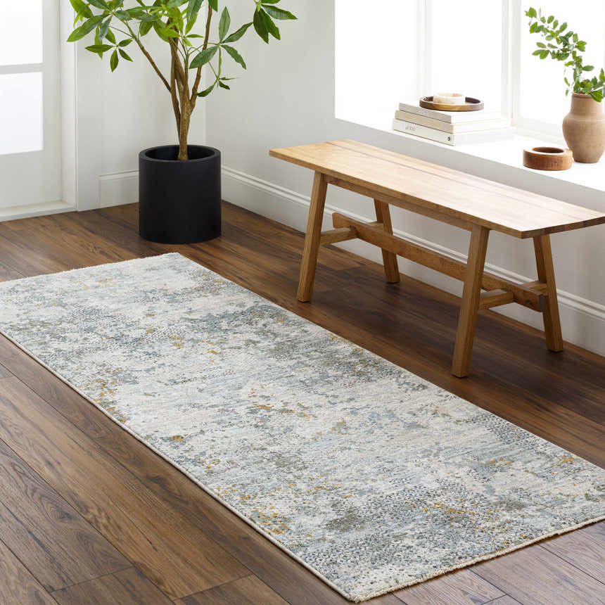 Entryway with Pizi Textured Rug runner in light gray, blue, and mustard. Wood bench and potted plant create a welcoming space. Roomscene-Runner