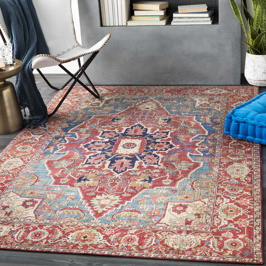 Living room scene with a red and blue Seattle Area Rug. Modern chair, blue throw, and bright blue cushion. Roomscene-Rectangle