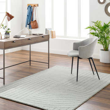 Home office with wood desk, gray chair, and light gray Ayumi Area Rug with subtle geometric pattern. Roomscene-Rectangle