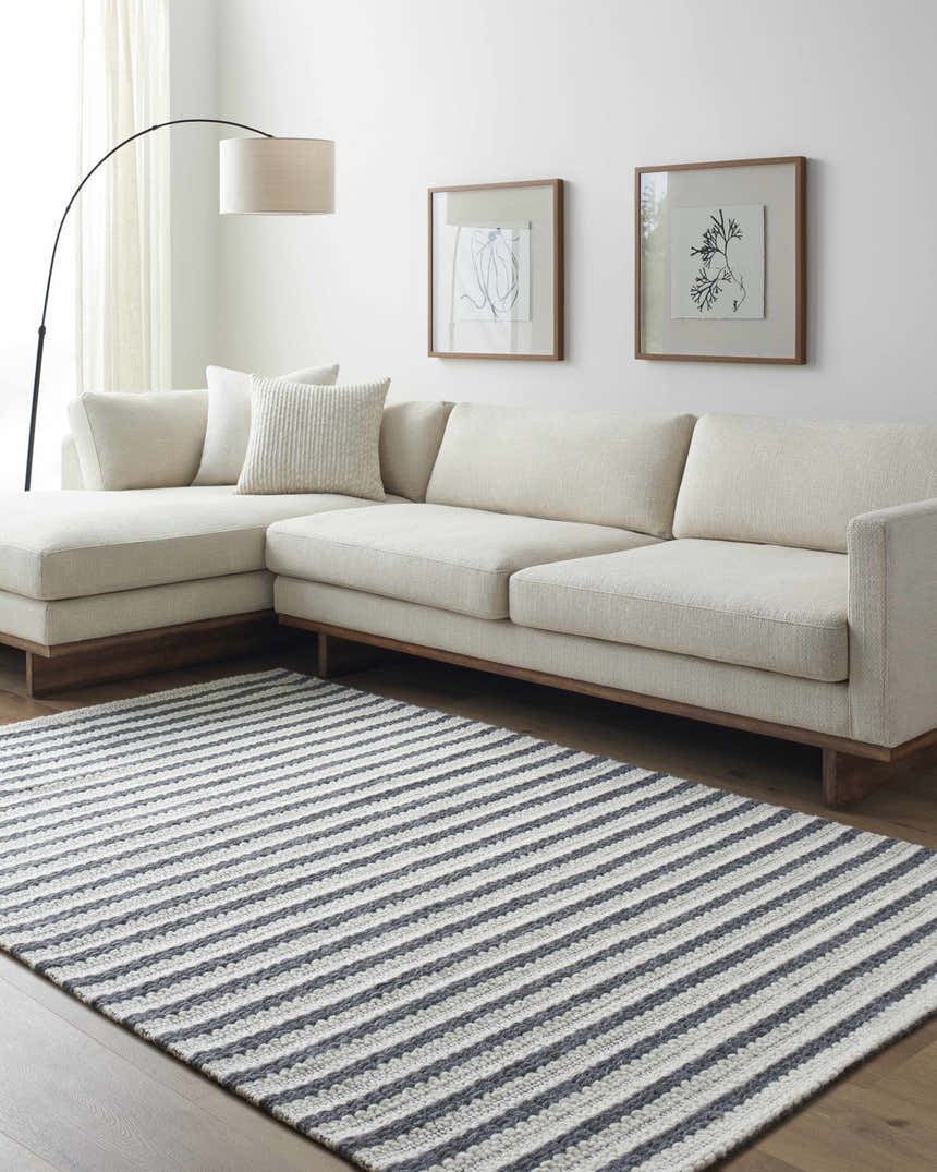 Living room with a cream sectional sofa and Laleh Cream & Gray Area Rug with bold stripes. Roomscene-Rectangle