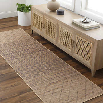 Entryway with Inali Washable Area Rug in camel and brown, styled with wood console table and potted plant. Roomscene-Runner