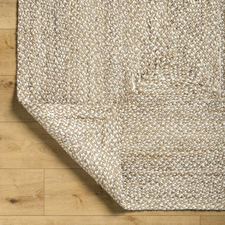 Close up of the Elkie Area Rug showing lambswool and light brown jute texture on wood floor. Fold