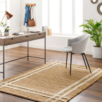 Farmhouse home office with wood desk, gray chair, and the Kazu Area Rug in natural jute with off-white border. Roomscene-Rectangle