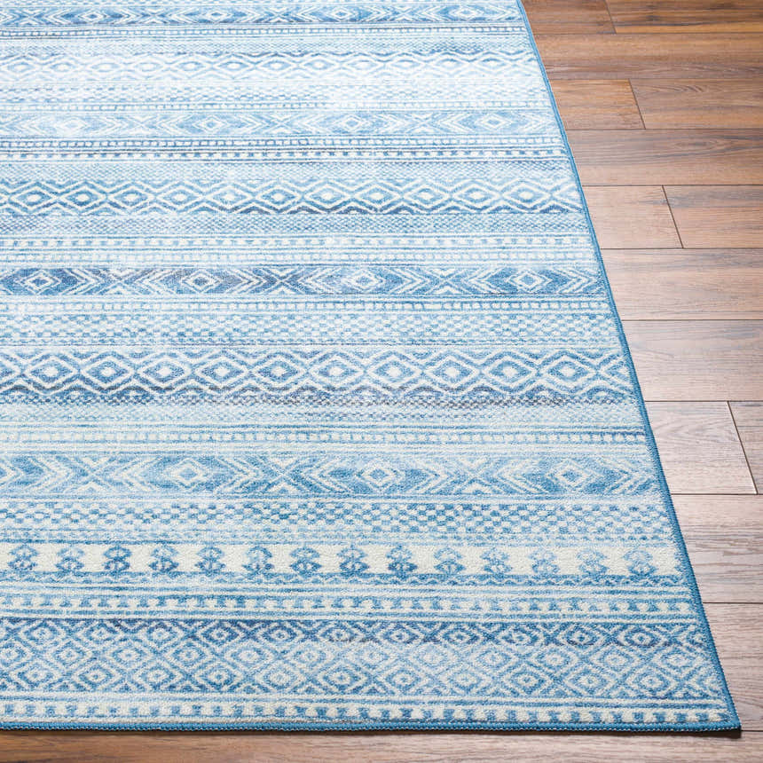 Close-up of Gizeh Arctic Stone Washable Area Rug. Features a geometric pattern in arctic stone, gray, and blue hues. Front