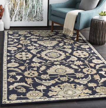 Living room scene with a Caesar CAE-1164 Black Floral Wool Rug, blue chair, and modern art. Roomscene-Rectangle