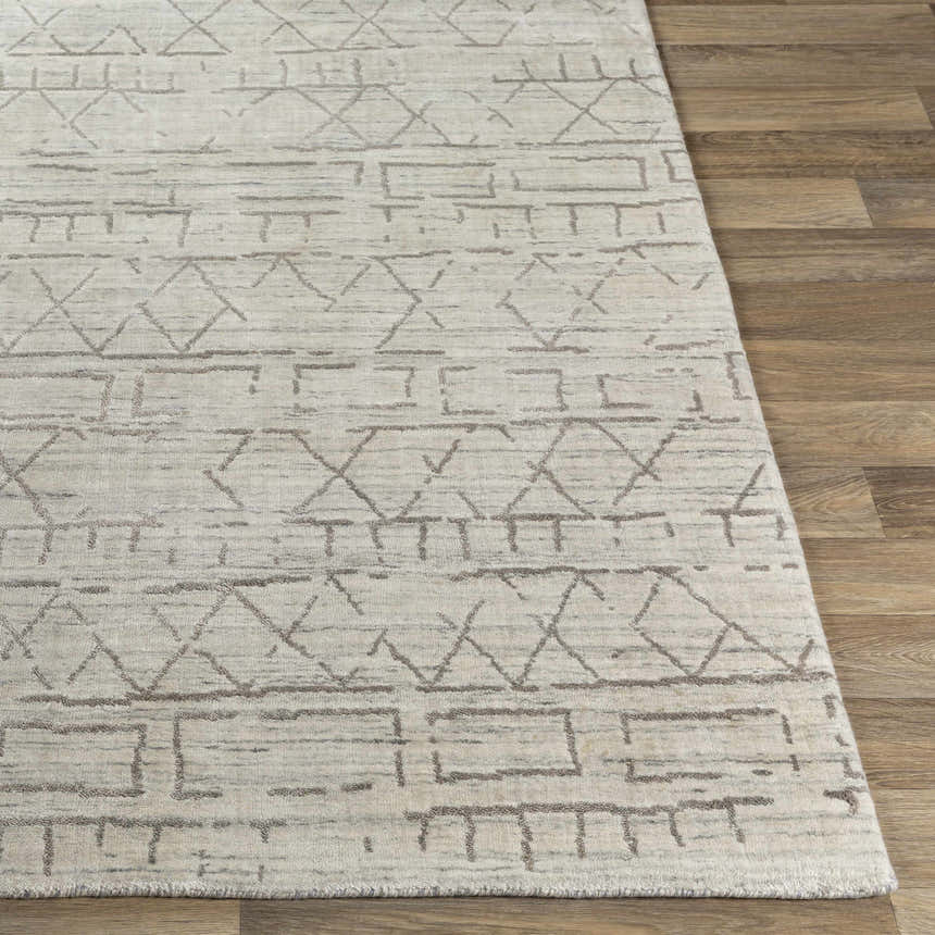 Close-up of Shortland Premium Area Rug in gray and ivory, featuring a geometric tribal pattern and hand-loomed texture. Front