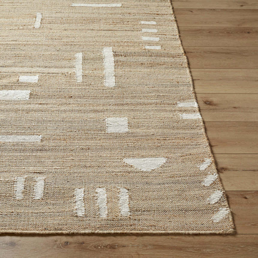Close up of the Sasha Jute Rug showing cream geometric patterns on a tan, hand woven jute texture. Farmhouse style. Front