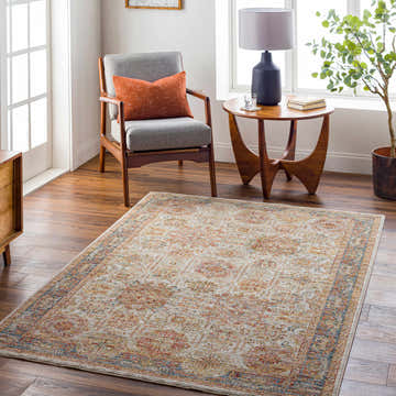 Living room scene with Ange Tan & Blue Rich Textured Traditional Rug, gray chair, and wood accents. Roomscene-Rectangle