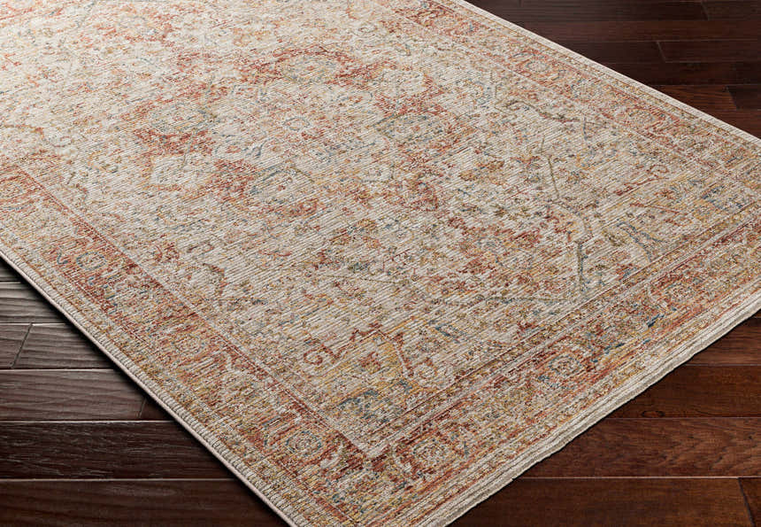 Close-up of the Cress Rust Rich Textured Traditional Rug showing its clay, peach, and brown colors and traditional pattern. Corner