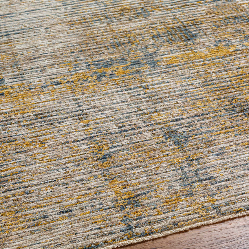 Close-up of the Osma Rich Textured Traditional Rug showing bone, driftwood, brown, and blue colors. Texture