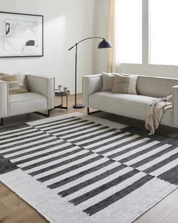 Living room with neutral sofa and Soren Black&White Jute Area Rug featuring bold stripes. Roomscene-Rectangle