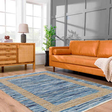 Living room with Ghita Recycled Blue Jean Rug, orange sofa, wood cabinet, and gray wall. Contemporary style. Roomscene-Rectangle