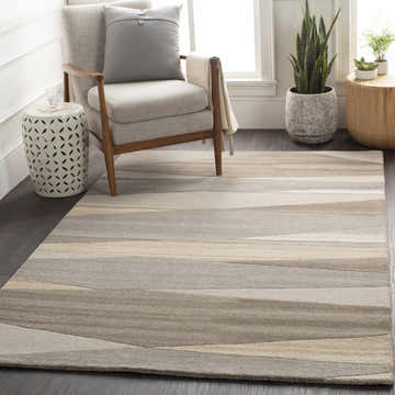 Living room scene with a Forum Taupe Modern Wool Rug, gray chair, side tables, and plants. Neutral, contemporary style. Roomscene-Rectangle