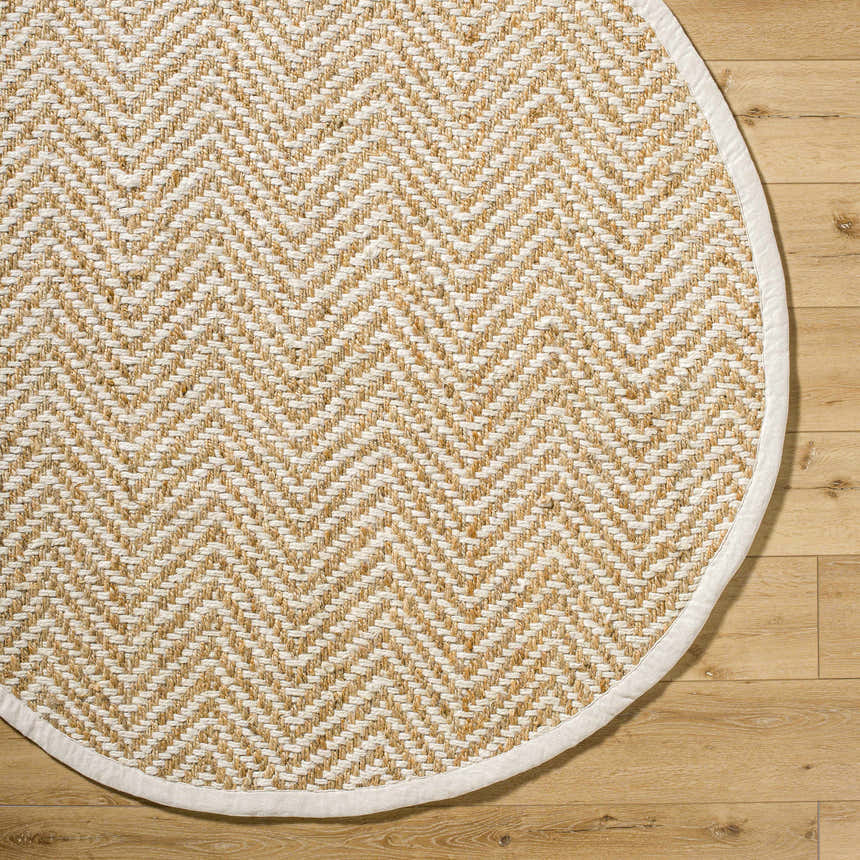 Close-up of round Aren Area Rug. Jute rug with a geometric herringbone pattern in natural and light beige colors. Corner