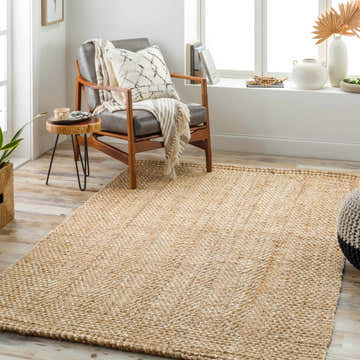 Living room with a Dinah Natural Textured Jute Rug, wood chair, and neutral decor for a warm, inviting feel. Roomscene-Rectangle
