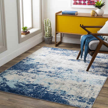 Living room scene with a contemporary Slamannan area rug in aqua, charcoal, and blue. Roomscene-Rectangle
