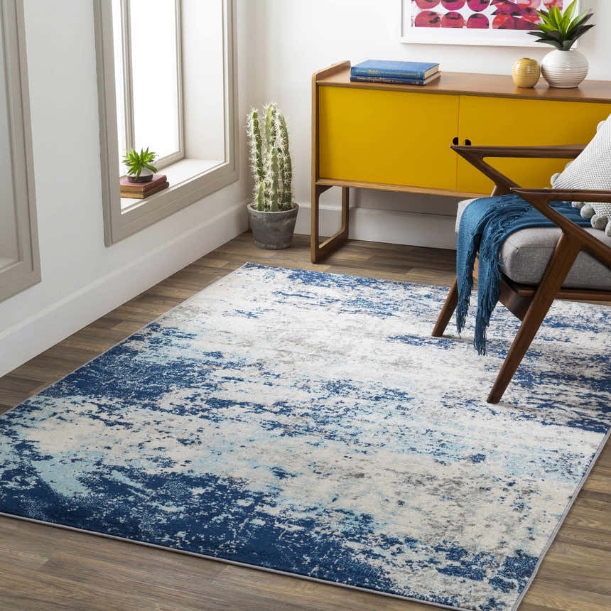 Living room scene with a contemporary Slamannan area rug in aqua, charcoal, and blue. Roomscene-Rectangle
