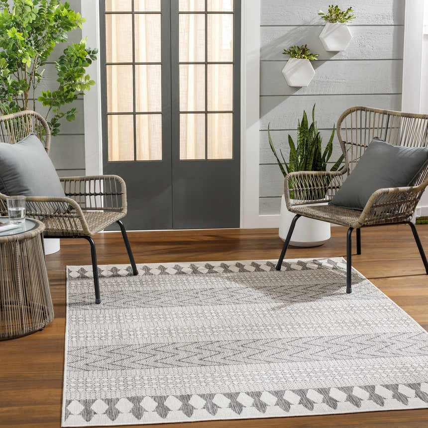 Patio scene with gray Asif Gray Area Rug, wicker chairs, and plants. Farmhouse style. Roomscene-Rectangle