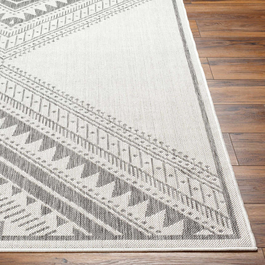 Close-up of Deana Light Gray Area Rug showing geometric pattern and texture on a wood floor. Front
