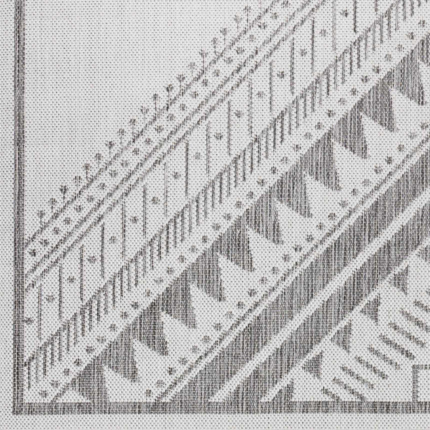 Close-up of the Deana Light Gray Area Rug, featuring a geometric pattern in light gray, medium gray, and off-white hues. Swatch