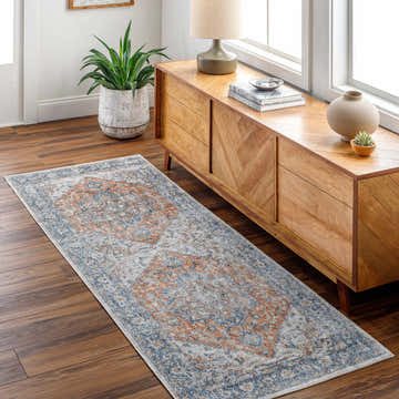 Entryway with wood floors and a mid-century console featuring the Ezri Rust Washable Area Rug runner. Roomscene-Runner