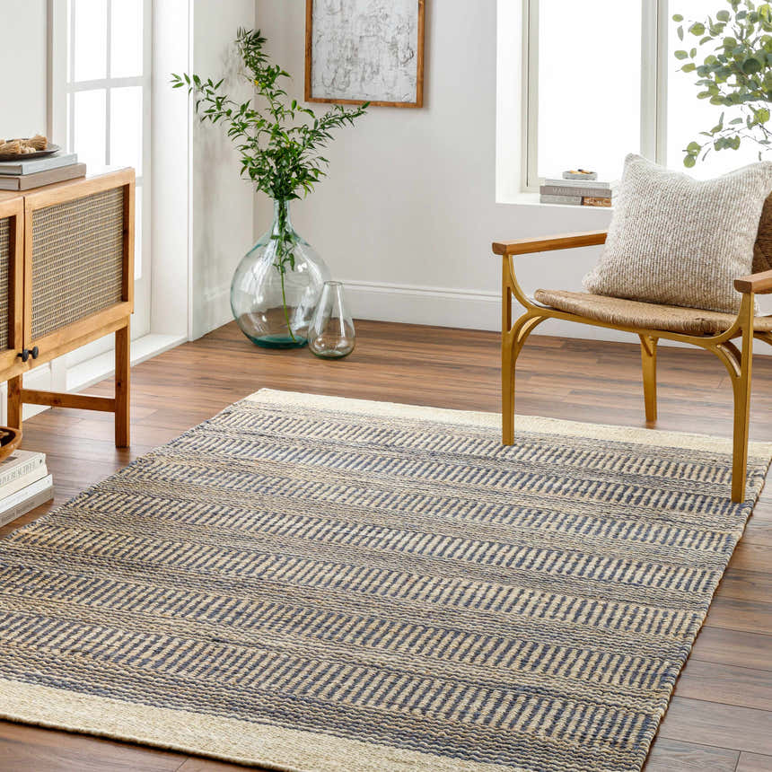 Living room scene with the blue Elle Area Rug, jute rug with geometric pattern, wood furniture, and natural light. Roomscene-Rectangle