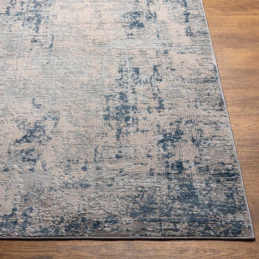 Close-up of the Saltair Textured Luxe Rug showing its blue, gray, and off-white abstract pattern and textured weave. Front