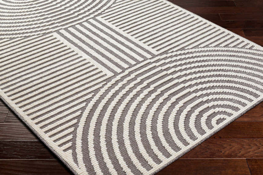 Close-up of the Deron Gray Rainbow Washable Rug featuring a contemporary geometric design in gray and white. Corner