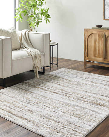 Living room scene with a Skule Beige Area Rug, light sofa, wood cabinet, and dark wood floors. Roomscene-Rectangle