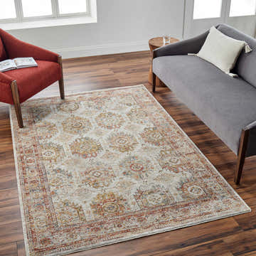 Living room scene with a Crescentia Cream Textured Rug, gray sofa, and brick red chair. Roomscene-Rectangle