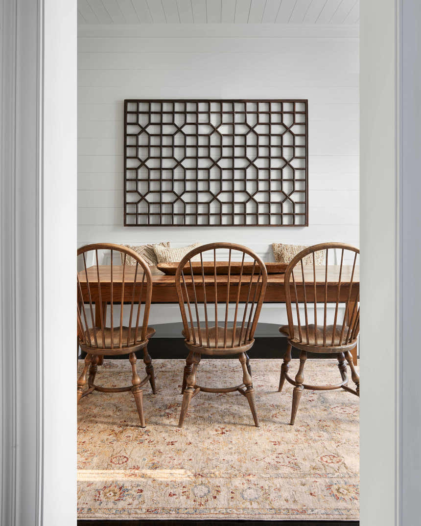 Farmhouse dining room with wood table and chairs on a Duong Beige Textured Rug. White walls and natural light. Roomscene-Rectangle