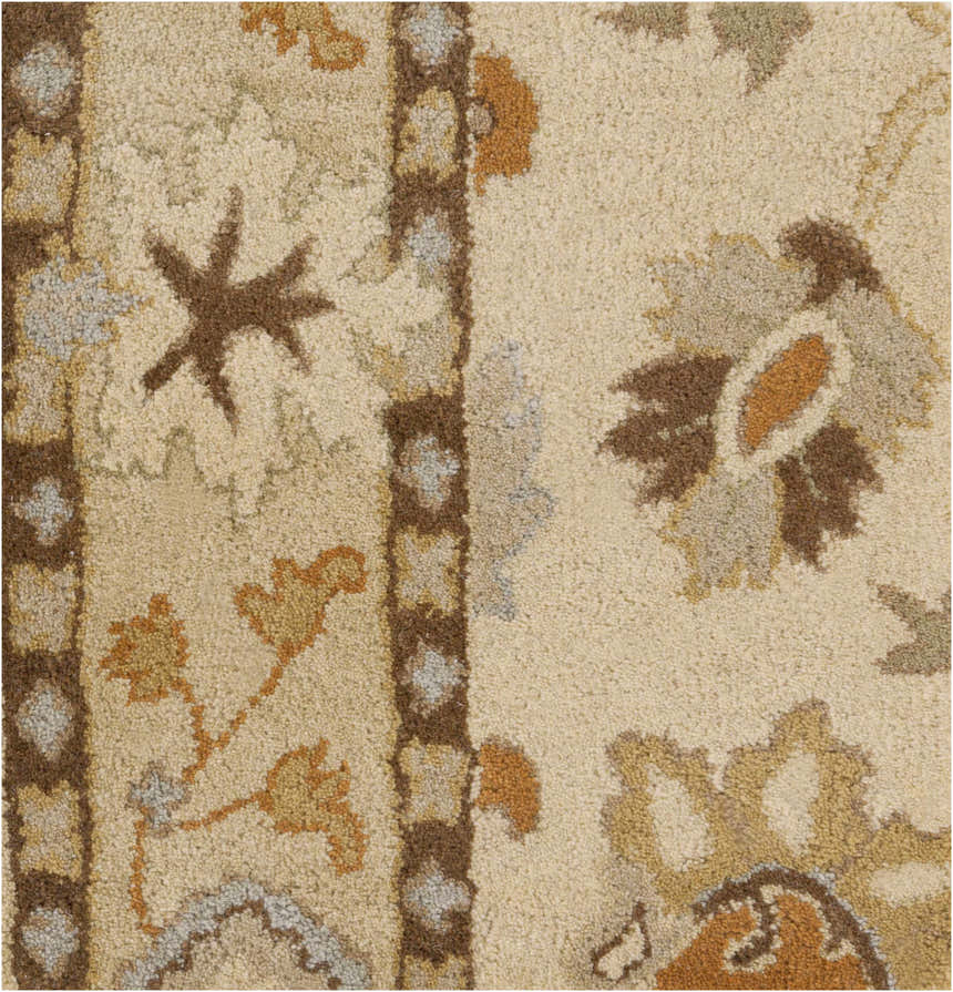 Close-up of the hand-tufted Smoot Area Rug. Beige wool rug with traditional brown, orange, and slate floral and geometric patterns. Swatch