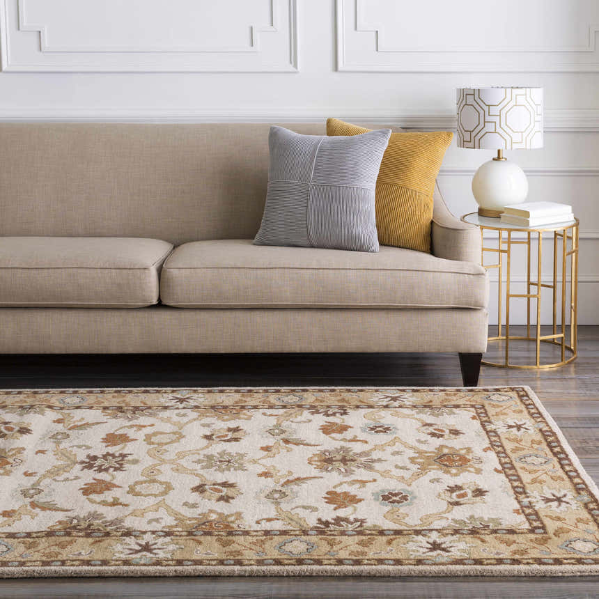 Living room scene with a beige sofa and the floral, traditional Smoot Area Rug in brown, beige, and blue. Roomscene-Rectangle