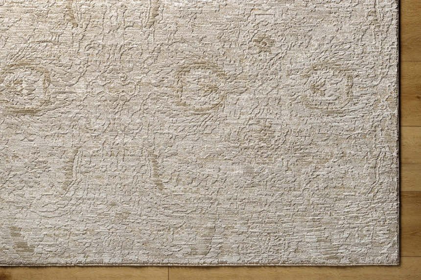 Close-up of the light gray and natural gray Katia Area Rug showing the textured, machine-woven design. Corner