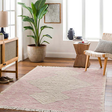 Living room scene with a pink Sang Area Rug, wood furniture, and a large potted plant. Roomscene-Rectangle