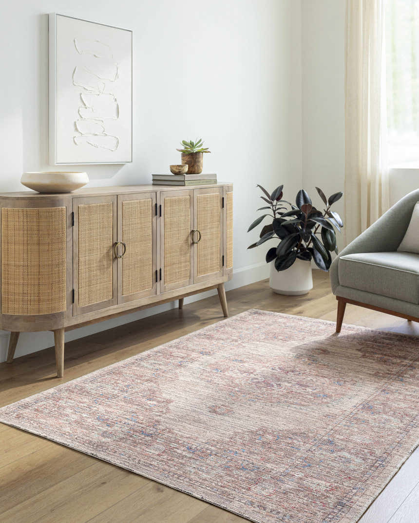 Living room scene with a Beachhouse Maja Area Rug, wood cabinet, gray chair, and modern art. Roomscene-Rectangle