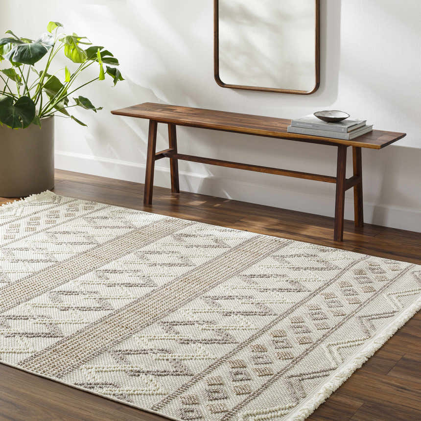 Entryway with Faruq Area Rug, beige and brown geometric pattern, wood bench, mirror, and potted plant. Roomscene-Rectangle