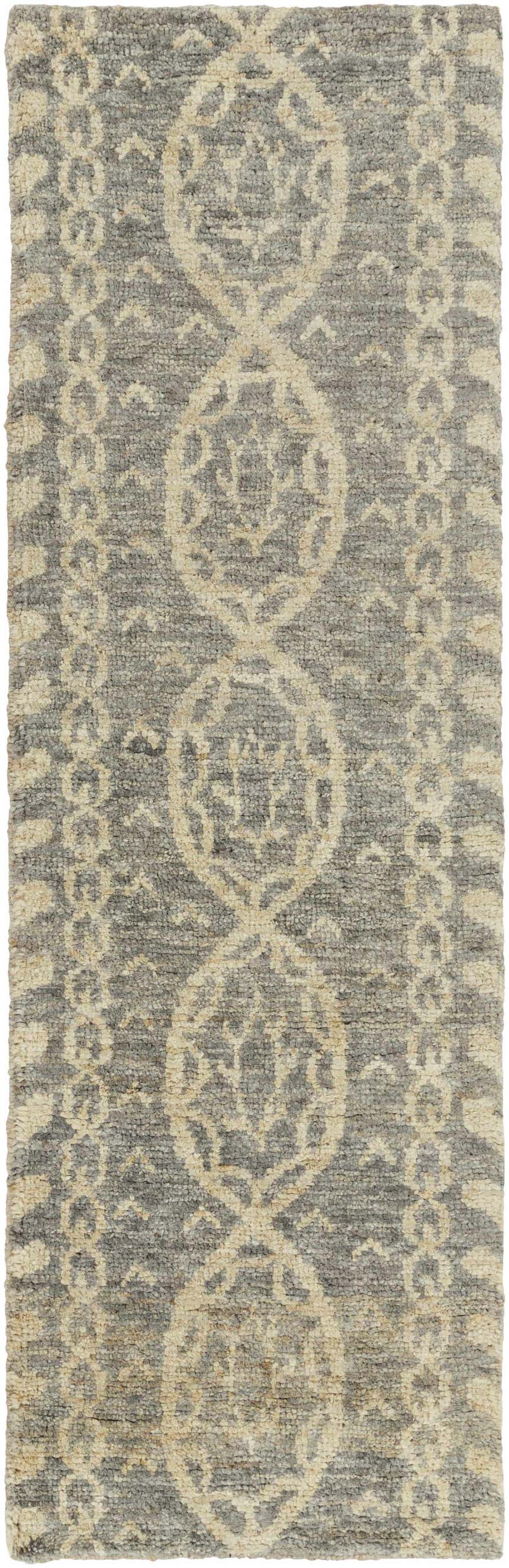 Close-up of the hand-knotted Sonnette Jute Rug. Brown, gray, and ivory jute rug with farmhouse style pattern. Design-Runner-268